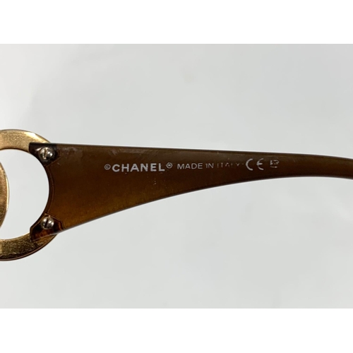 667 - A pair of ladies Chanel sunglasses in case.