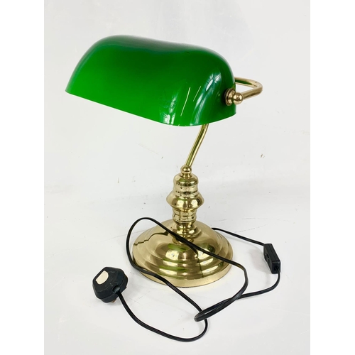 67 - A brass desk lamp with glass shade. 38cm