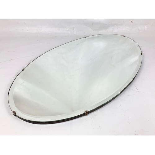 69 - A 1930’s bevelled mirror. 65.5 x 37cm