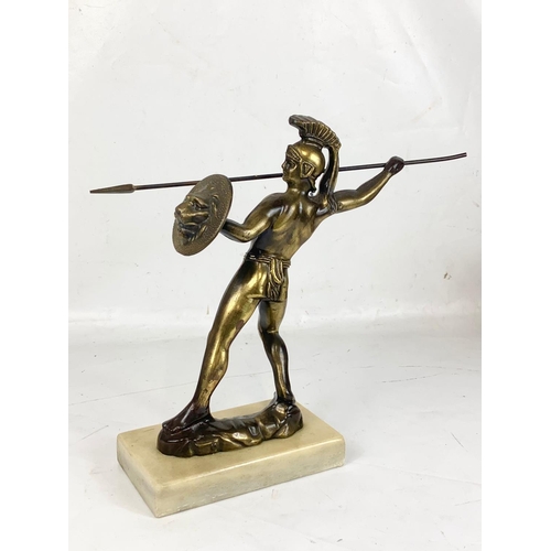 75 - A vintage brass figure on a marble base. 32cm.