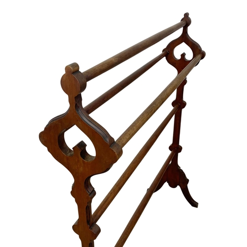 785 - A Victorian walnut towel rail in the manner of Pugin in the Neo Gothic style. 78 x 92cm.