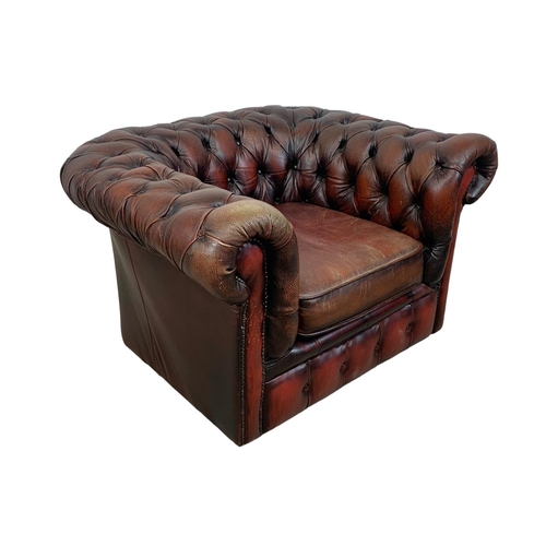 787 - A vintage deep button ox-blood leather Chesterfield club armchair. 104 x 86 x 63cm.