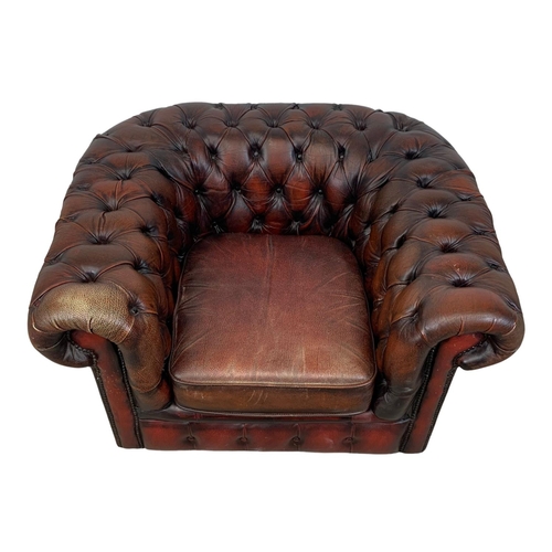 787 - A vintage deep button ox-blood leather Chesterfield club armchair. 104 x 86 x 63cm.