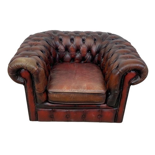 787 - A vintage deep button ox-blood leather Chesterfield club armchair. 104 x 86 x 63cm.