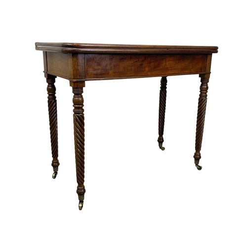 793 - A Regency mahogany tea table with rosewood cross banding, Nelson Twist legs, and quality reeded bras... 