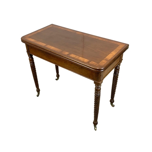 793 - A Regency mahogany tea table with rosewood cross banding, Nelson Twist legs, and quality reeded bras... 