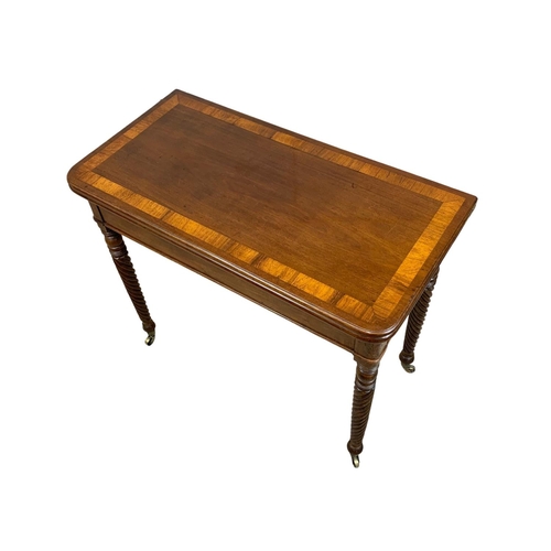 793 - A Regency mahogany tea table with rosewood cross banding, Nelson Twist legs, and quality reeded bras... 