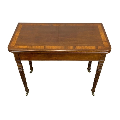 793 - A Regency mahogany tea table with rosewood cross banding, Nelson Twist legs, and quality reeded bras... 