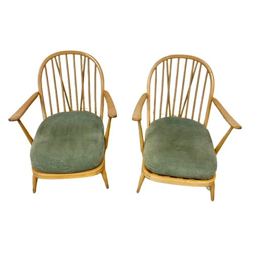 798 - A pair of Ercol Blonde elm Mid Century armchairs. Model 203.