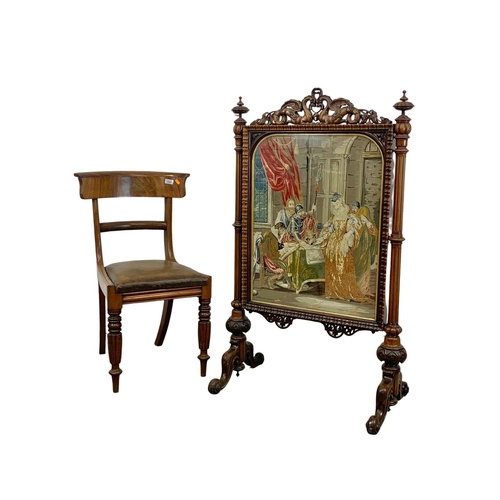 799 - A large Victorian carved rosewood firescreen with tapestry panel. Circa 1860. 79 x 44 x 123cm.