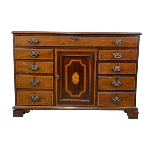 817 - A large late 18th century inlaid mahogany chest of drawers with inlaid panel door. In the Sheraton s... 