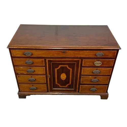 817 - A large late 18th century inlaid mahogany chest of drawers with inlaid panel door. In the Sheraton s... 