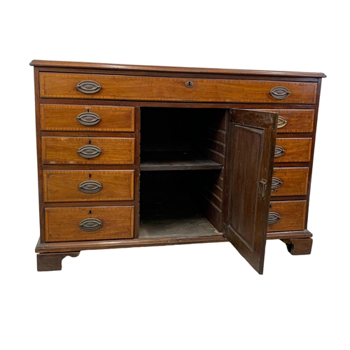 817 - A large late 18th century inlaid mahogany chest of drawers with inlaid panel door. In the Sheraton s... 