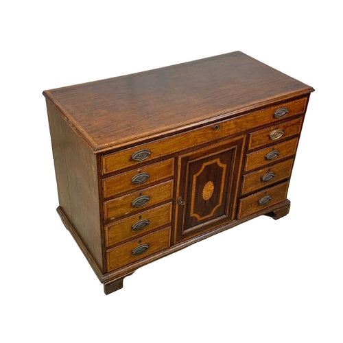 817 - A large late 18th century inlaid mahogany chest of drawers with inlaid panel door. In the Sheraton s... 