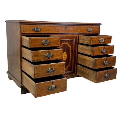 817 - A large late 18th century inlaid mahogany chest of drawers with inlaid panel door. In the Sheraton s... 