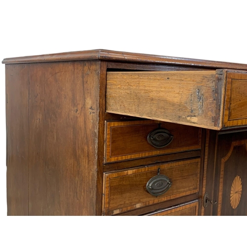 817 - A large late 18th century inlaid mahogany chest of drawers with inlaid panel door. In the Sheraton s... 