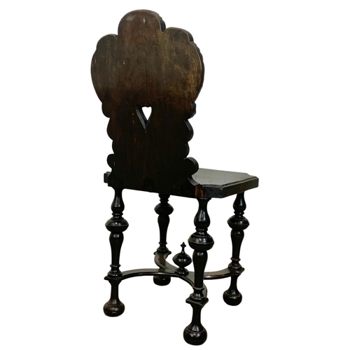 827 - A pair of 19th century continental carved oak hall chairs in the medieval style. Circa 1880.