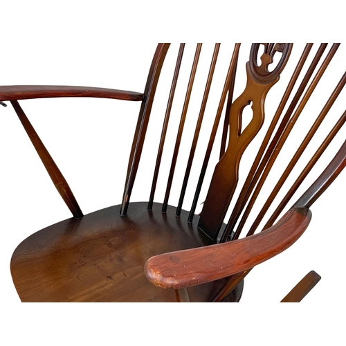 839 - A large Ercol Windsor elm rocking chair. Mid Century. 1960.