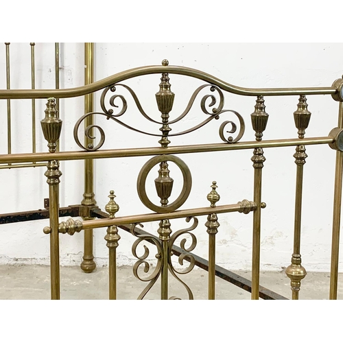 840 - A large Victorian heavy brass bed. 147 x 214 x 155cm.