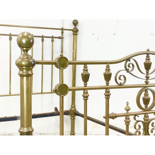 840 - A large Victorian heavy brass bed. 147 x 214 x 155cm.