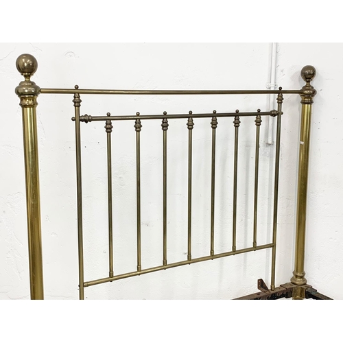 840 - A large Victorian heavy brass bed. 147 x 214 x 155cm.