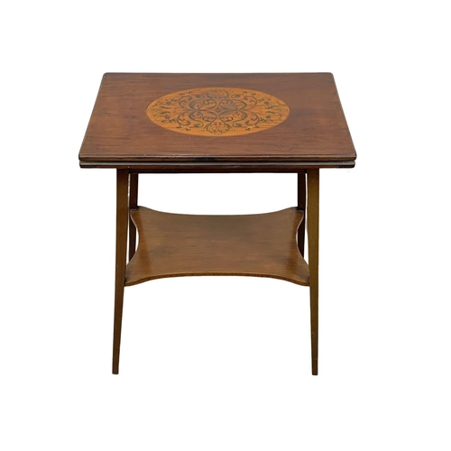 841 - An Edwardian inlaid mahogany turnover games table. 55.5 x 37 x 69.5cm.