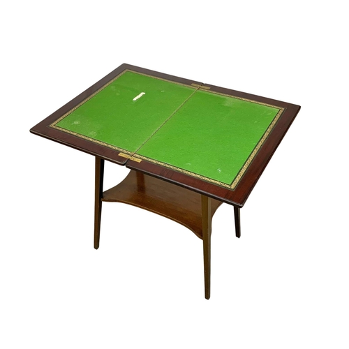 841 - An Edwardian inlaid mahogany turnover games table. 55.5 x 37 x 69.5cm.