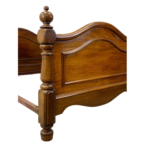 848 - A Victorian heavy mahogany double bed. 134.5 x 214 x 105cm