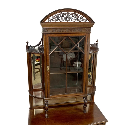 856 - A late Victorian mahogany display cabinet on chest. With Cabriole legs, open and closed Fretwork car... 