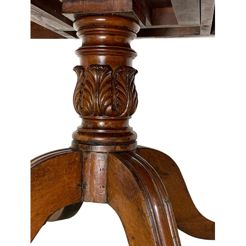 860 - A large George IV mahogany tilt top pedestal dining table, with rosewood cross banding, gadrooned ed... 