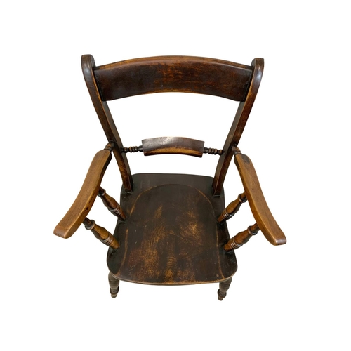 862 - A Victorian elm and beech Kitchen armchair