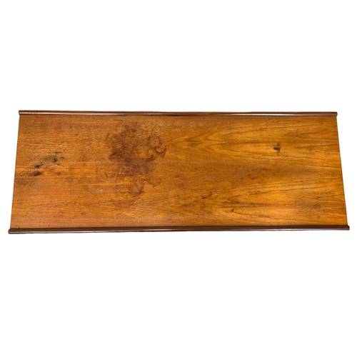 883 - A teak coffee table by Myer with slatted shelf. 122 x 45 x 49cm