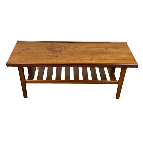 883 - A teak coffee table by Myer with slatted shelf. 122 x 45 x 49cm