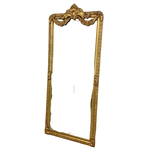 895 - A very large heavily gilt framed mirror. 90.5 x 212cm.