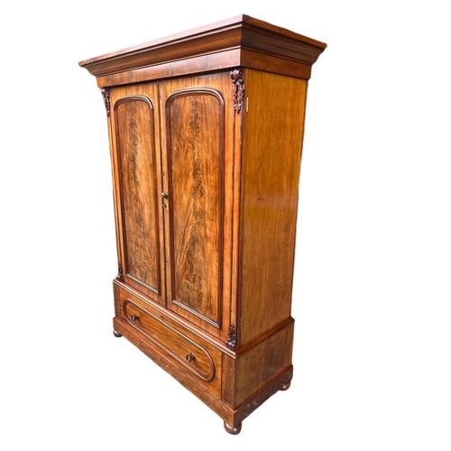 899 - A large Victorian mahogany double door wardrobe with shelves and drawer. Circa 1860-1870. 139 x 65 x... 