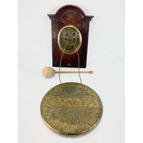 9 - A late 19th century brass wall hanging gong with bronze leopard. 40.5cm. Gong measures 30.5cm.