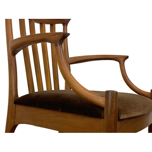 900 - A Mid Century teak armchair.