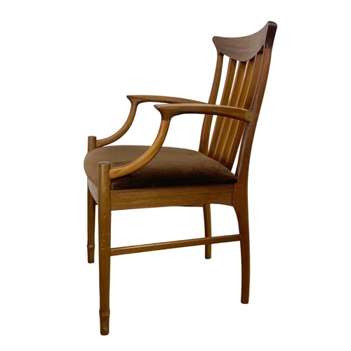 900 - A Mid Century teak armchair.