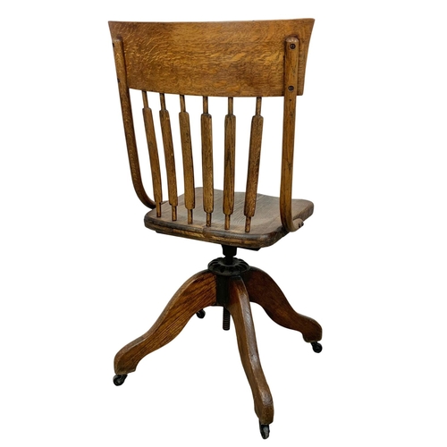 906 - An Edwardian oak swivel desk chair.