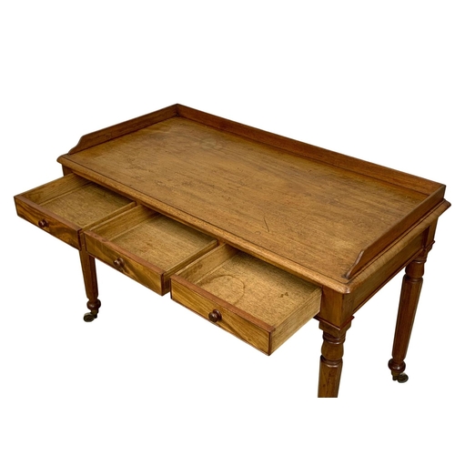 917 - A large early Victorian mahogany side table with gallery back and 3 drawers. Circa 1840-50. 122 x 60... 