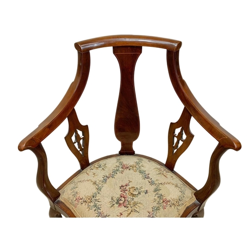 926 - An Edwardian inlaid mahogany high back corner armchair. Ground to back 92cm.