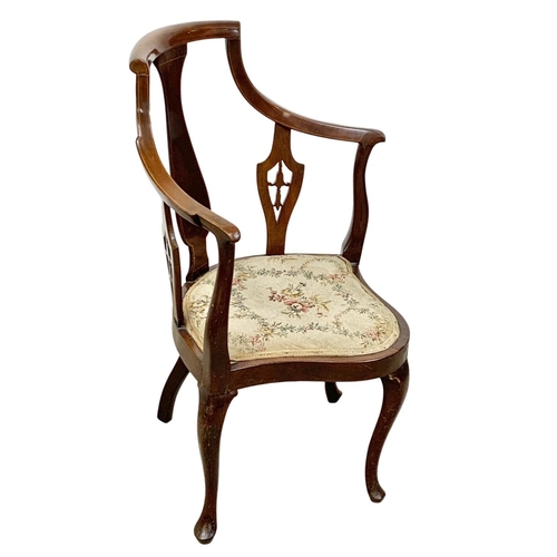 926 - An Edwardian inlaid mahogany high back corner armchair. Ground to back 92cm.