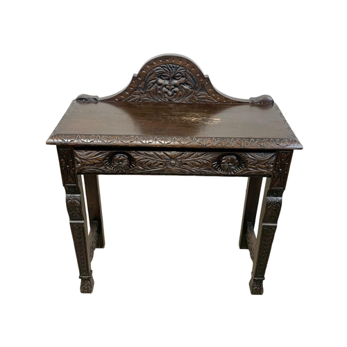 929 - A Victorian carved oak side table with gallery back and drawer. 91 x 38.5 x 104cm