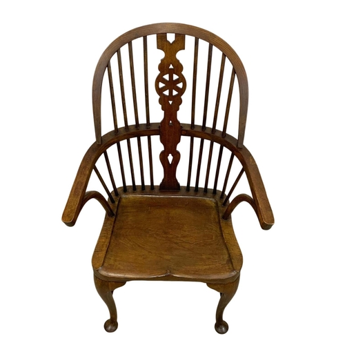 933 - An early 20th century elm and beech Windsor armchair. 61 x 50 x 106cm