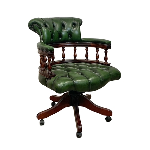 940 - A deep button green leather swivel captains desk chair