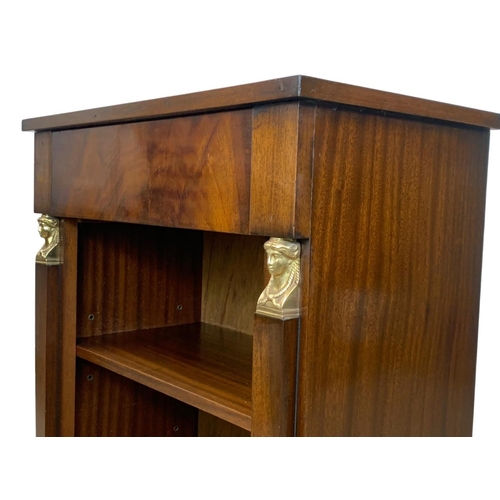 946a - A Regency style mahogany bookcase with drawer with Egyptian revival decoration. 61 x 35 x 92.5cm.