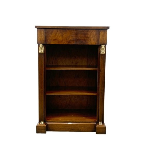 946a - A Regency style mahogany bookcase with drawer with Egyptian revival decoration. 61 x 35 x 92.5cm.