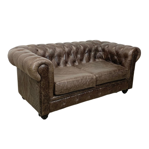 958 - A deep button brown leather Chesterfield sofa. 185 x 96 x 79cm