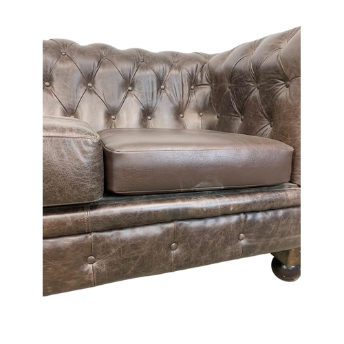 959 - A large deep button brown leather Chesterfield sofa. 223 x 91 x 83cm