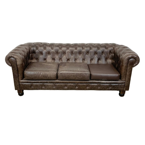 959 - A large deep button brown leather Chesterfield sofa. 223 x 91 x 83cm